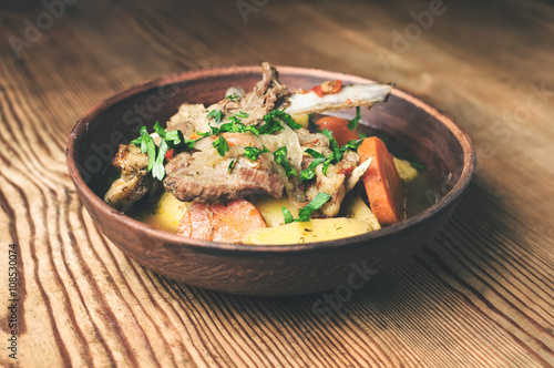 mutton stew on the wooden table, rustic style