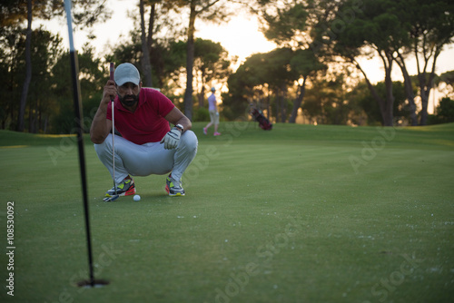 golf player aiming perfect shot on beautiful sunset