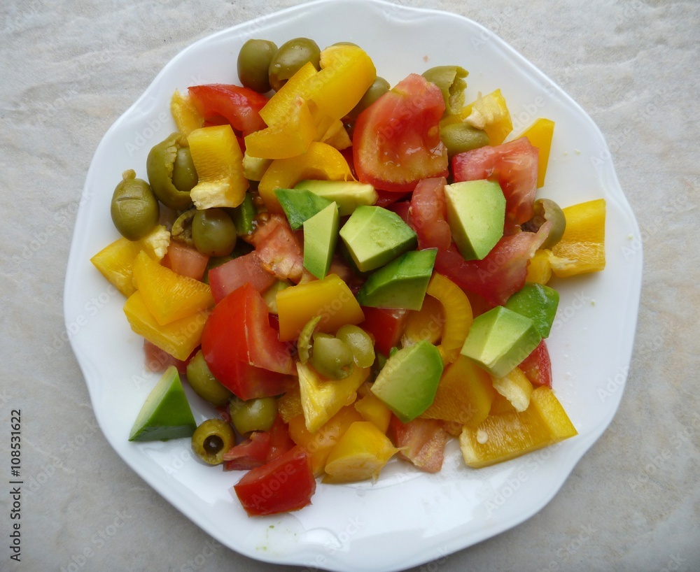 colorful vegetable salad with tomato pepper avocado ant olives