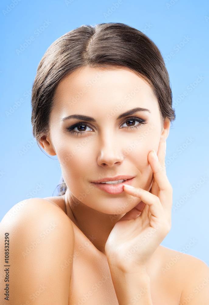 portrait of woman with naked shoulders, on blue portrait of woman with naked shoulders, on blue