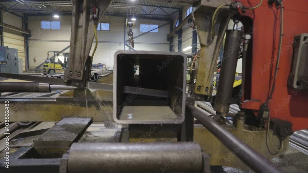 Closer look of the machine metal sawer with water dripping out of the machine while cutting Closer look of the machine metal sawer with water dripping out of the machine while cutting