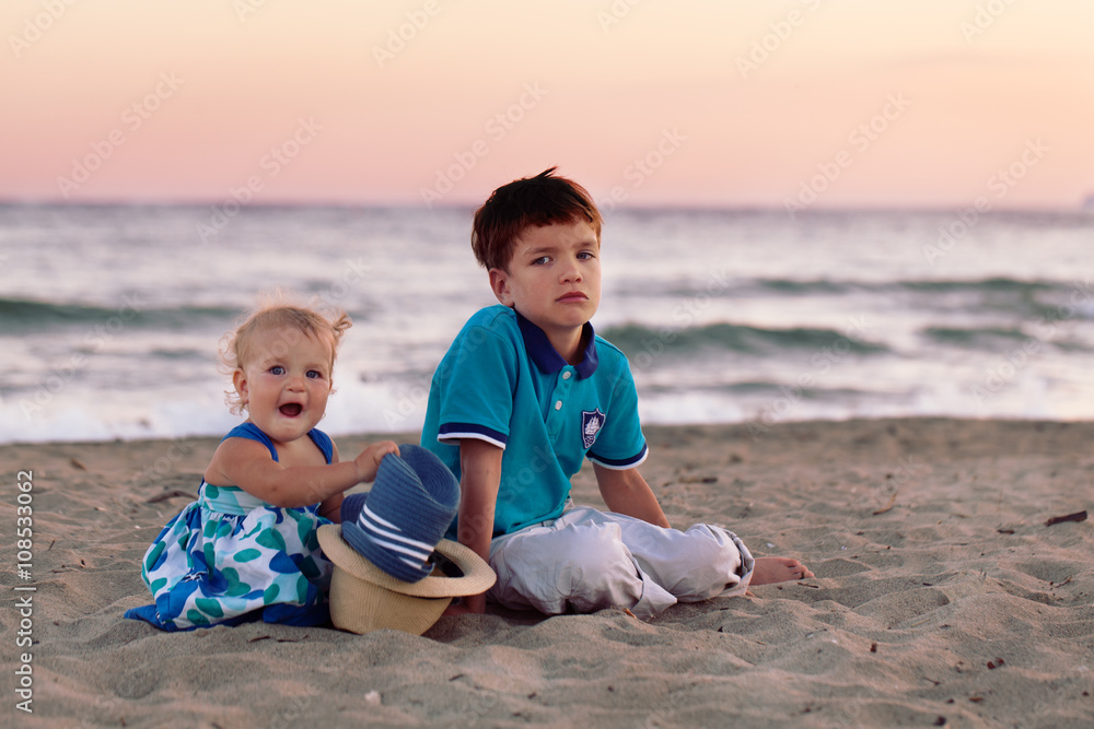 Happy elder brother is playing with his younger sister Happy elder brother is playing with his younger sister