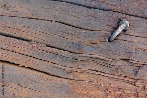 Wooden plank with a nail
