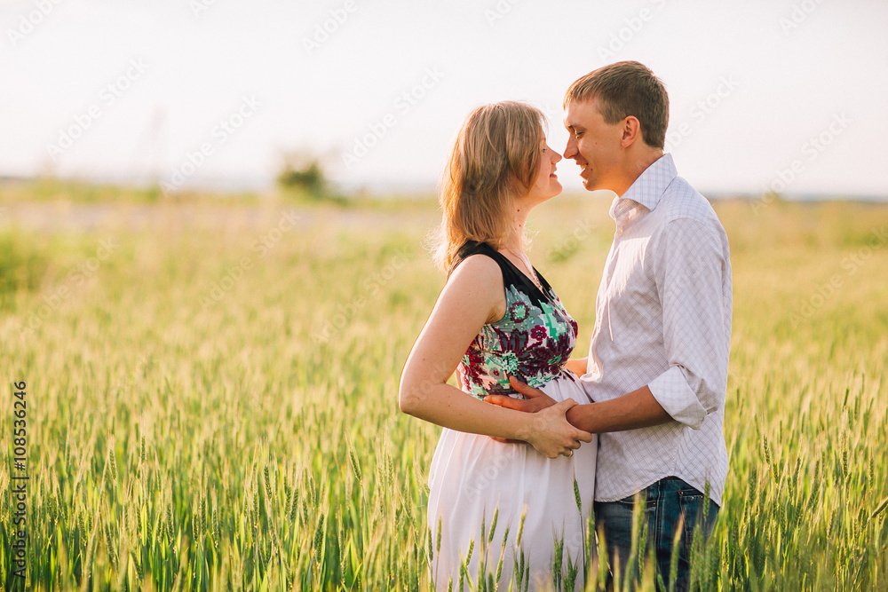 pretty pregnant with her husband in the field pretty pregnant with her husband in the field