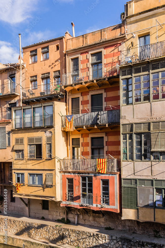 Colorful houses on Onyar River bank at sunset. Gerona, Spain.