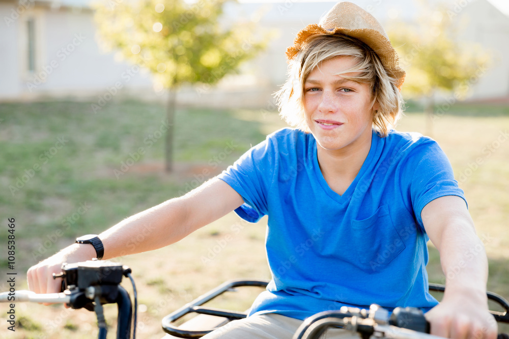 Fototapeta premium Boy riding farm truck in vineyard