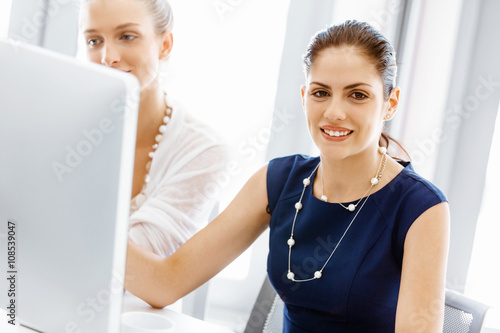Two female colleagues in office