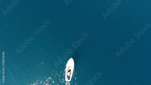 Small fishing boat on blue sea aerial view