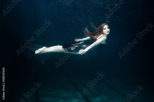 Woman swims underwater.