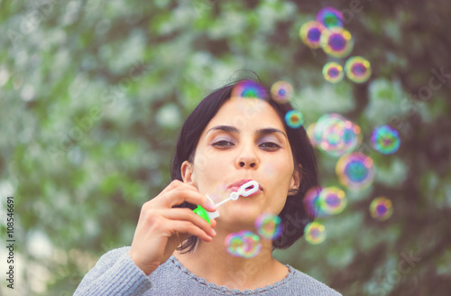 beautiful woman blowing bubbles