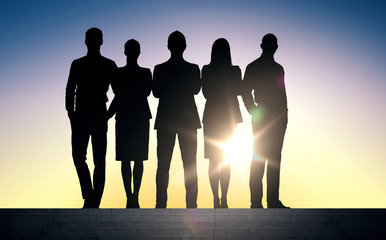 business people silhouettes on stairs over sun