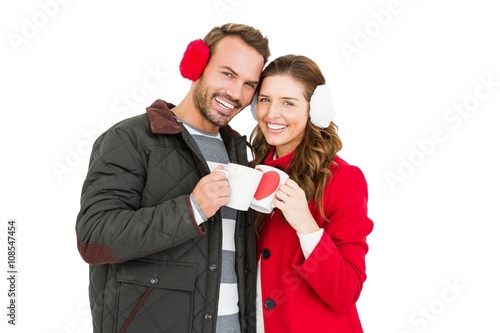 Happy young couple holding coffee mug