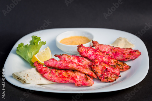 Pieces of fried fish in marinade served with pita bread