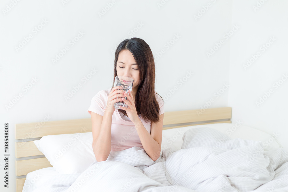 Woman drink of water at bed Woman drink of water at bed