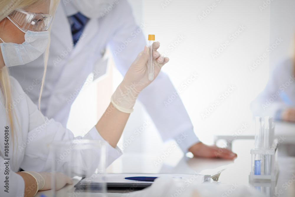 Scientific research team with clear solution in laboratory Scientific research team with clear solution in laboratory