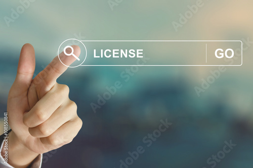 business hand clicking license button on search toolbar photo