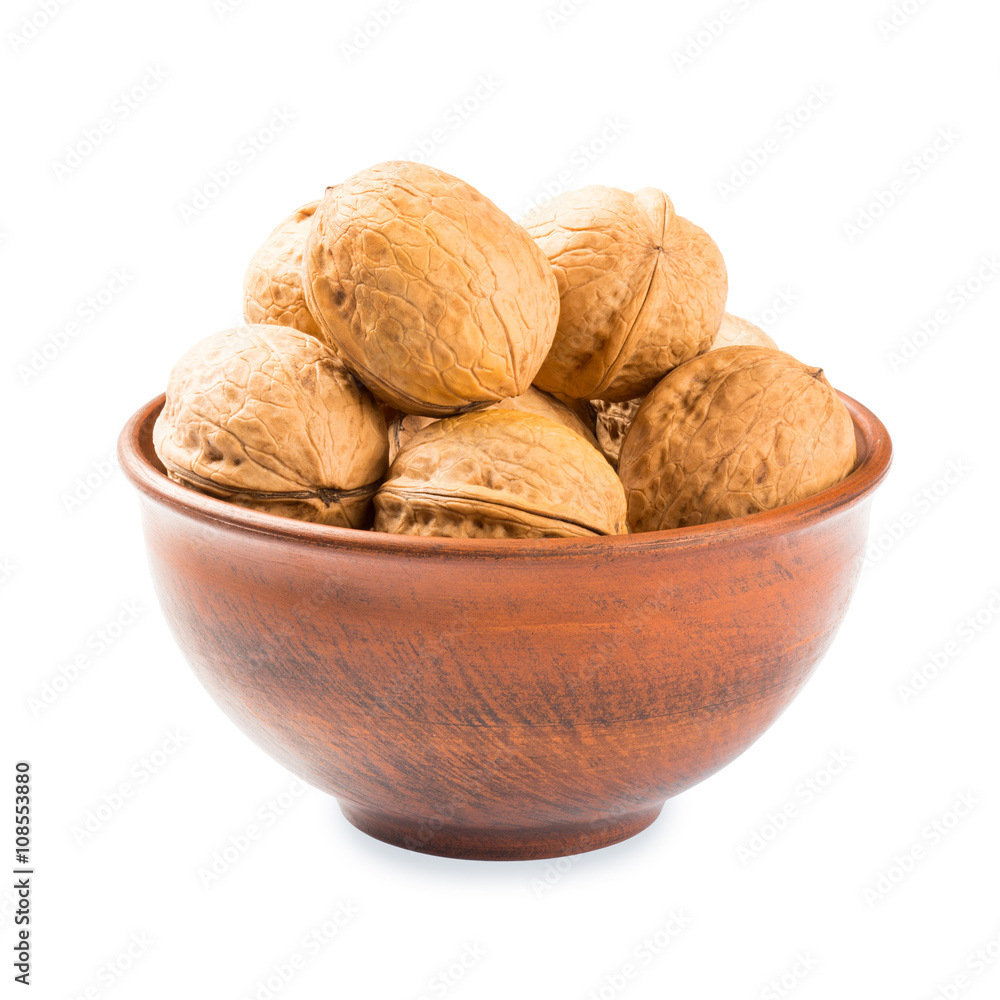 Walnuts in a clay bowl - isolated on white background Walnuts in a clay bowl - isolated on white background