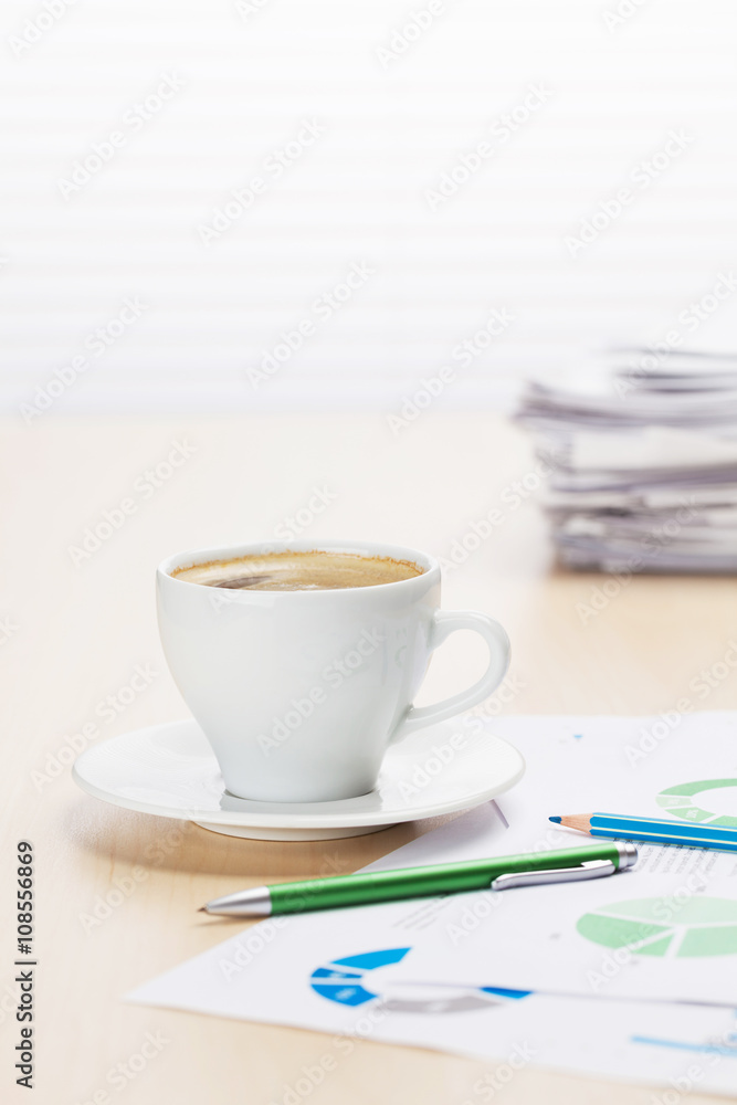 Office workplace with coffee, supplies and reports Office workplace with coffee, supplies and reports