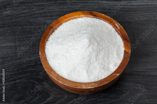 salt in bowl on the wooden table in kitchen