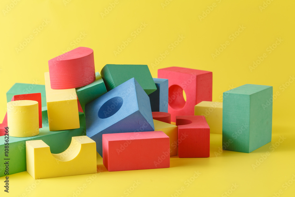 building blocks on yellow background building blocks on yellow background