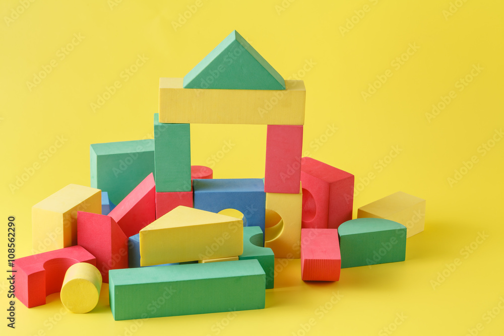 Obraz premium building blocks on yellow background