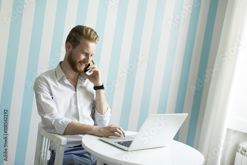 Man with a laptop and a phone