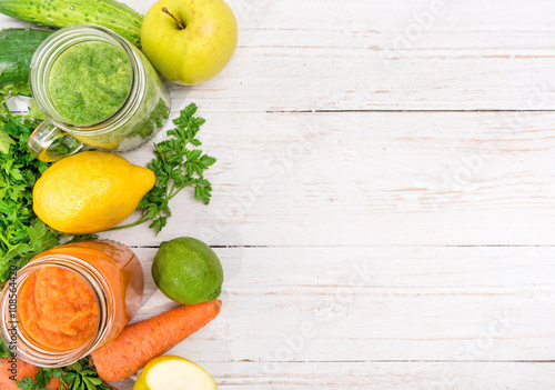 Vegetable smoothies in glass jars on a wooden background. Concept of cooking. 