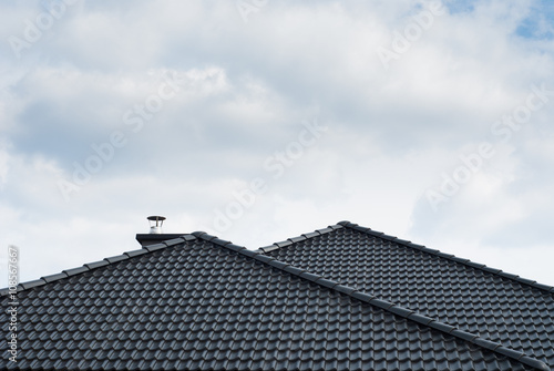 Black roof against cloudy sky
