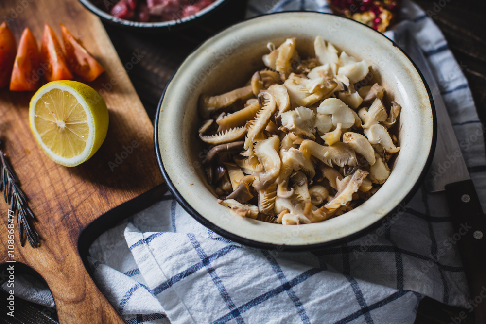 meat, mushrooms, tomatoes, vegetables and spices lie 