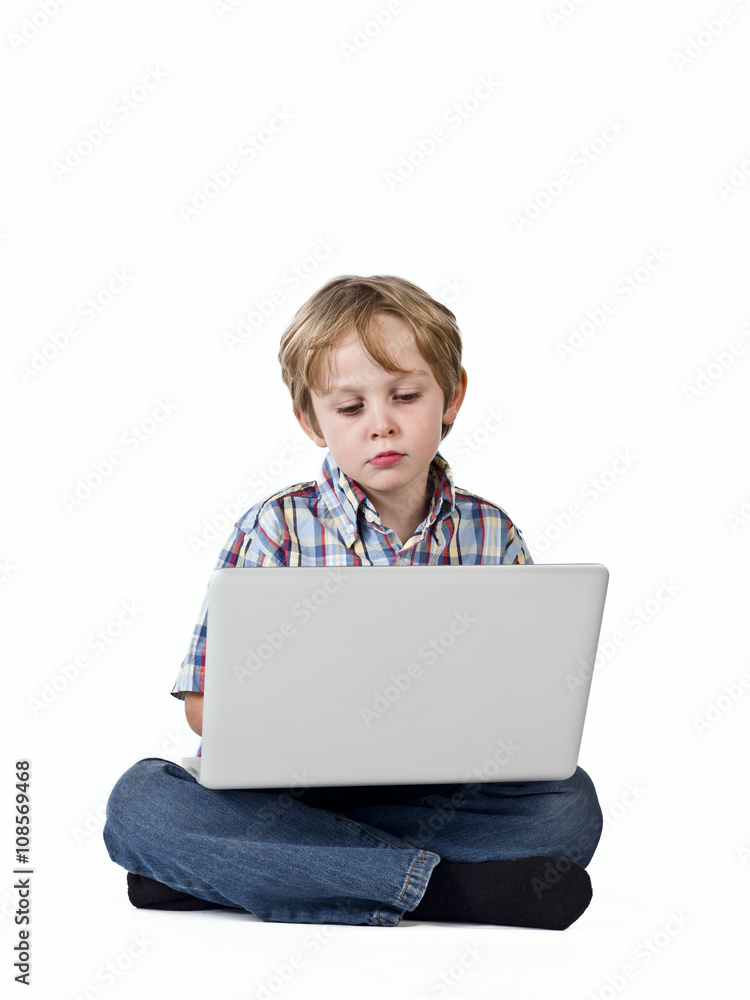 cute boy using laptop. cute boy using laptop.