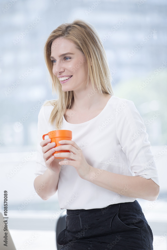 Beautiful Blond Business woman in Office drink Coffee Beautiful Blond Business woman in Office drink Coffee
