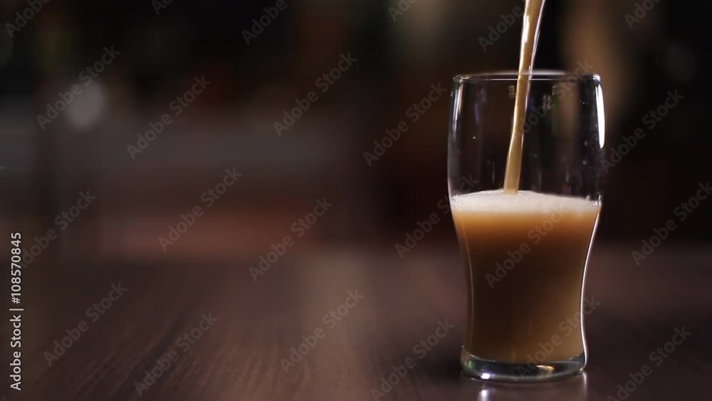 Dark beer poured into a glass Dark beer poured into a glass