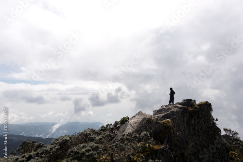 silhouette of single person on suimmit in ruwenzori mountains, uganda
