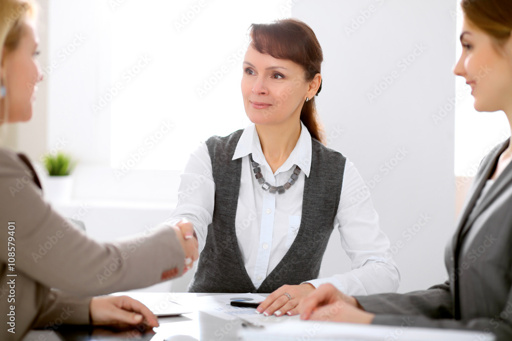 Business people shaking hands, finishing up a meeting Business people shaking hands, finishing up a meeting