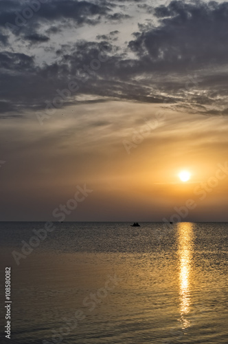 Sunset on the sea, the solar path, the people in the boat on the © esbuka