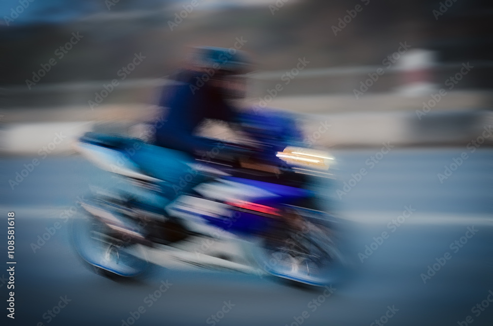 Fototapeta premium Blurred background with fast running motorcyclist