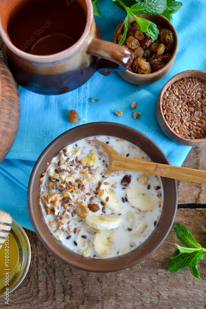 Granola with milk, walnuts and a banana for breakfast Granola with milk, walnuts and a banana for breakfast