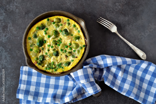 Frittata with cheese, green peas and Brussels sprouts