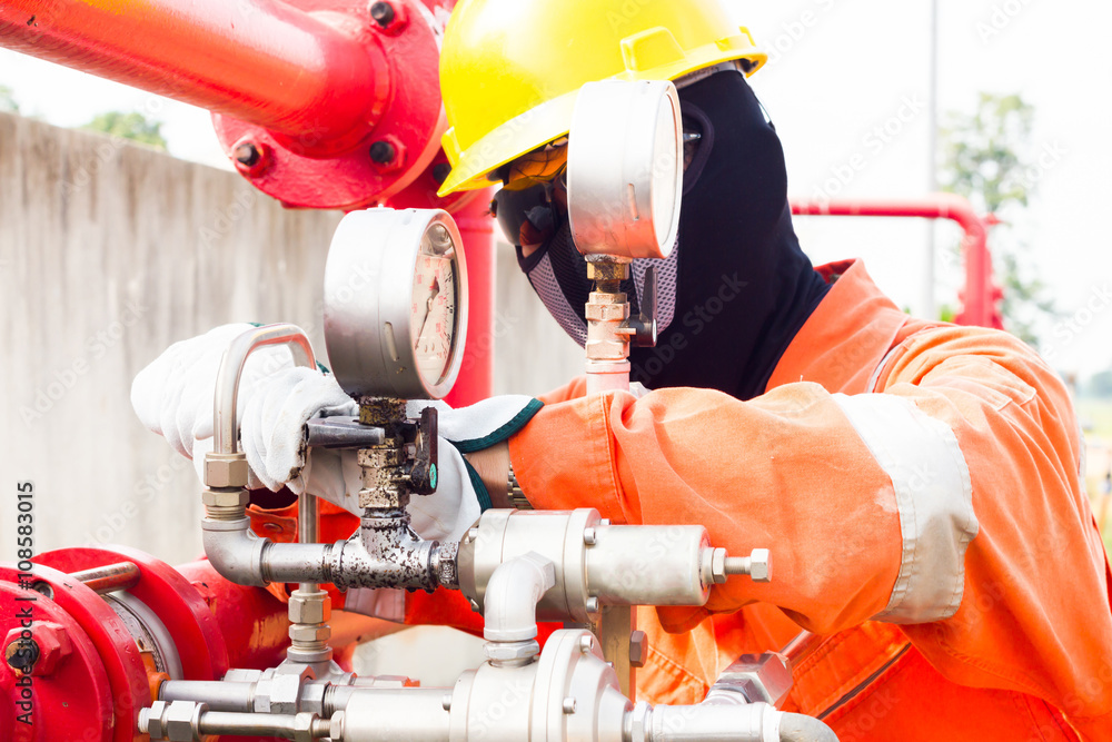 Close-up image of human hand fixing and stop leak of manometer by wrench in oil and gas process Close-up image of human hand fixing and stop leak of manometer by wrench in oil and gas process