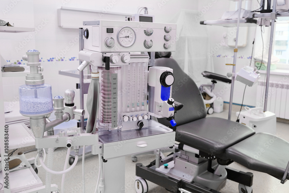 interior of the operating room in dental clinic with the anesthesiology machine on the frontground