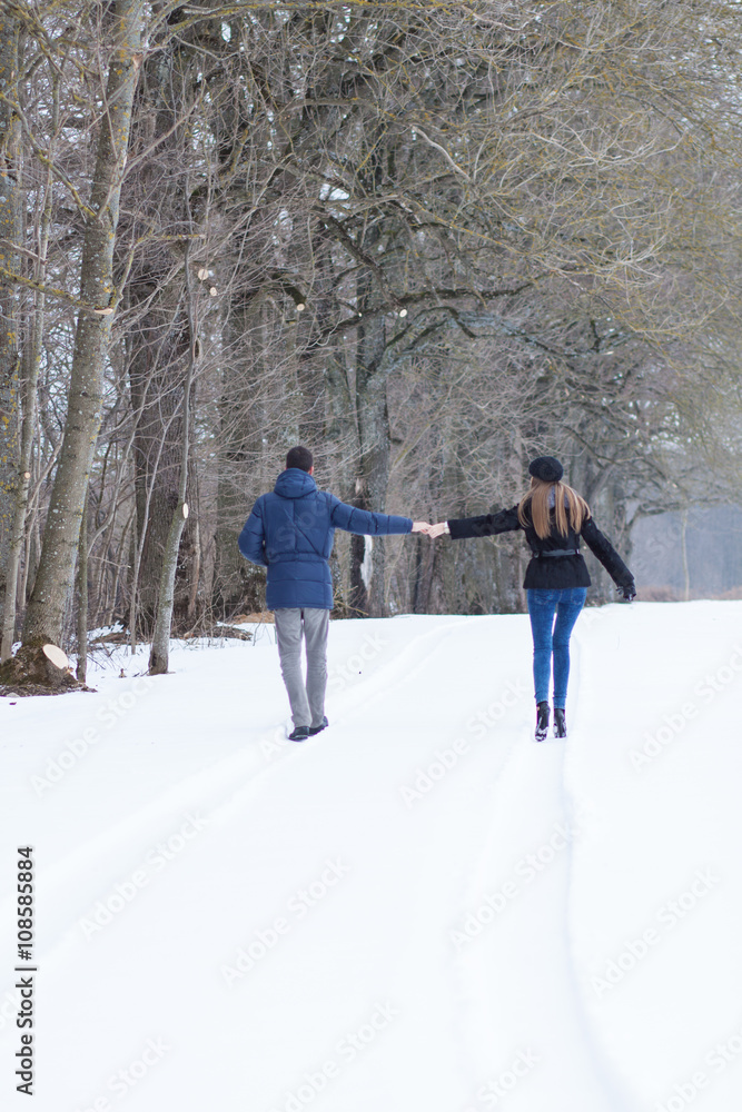 Couple walking in winter park Couple walking in winter park