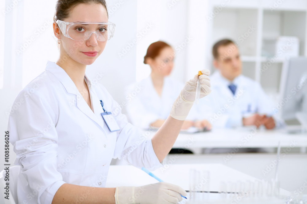 Scientific research team with clear solution in laboratory Scientific research team with clear solution in laboratory