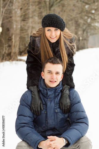Happy Young Couple in Winter Park having fun