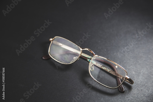 optical glasses on black table background