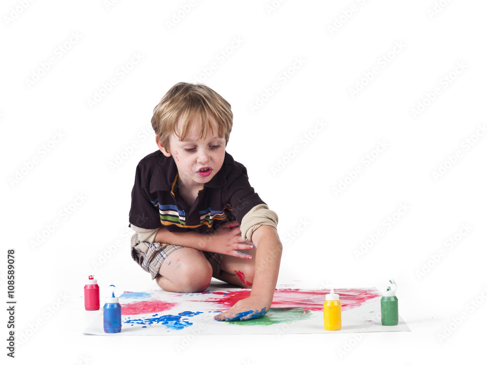 image of a elementary boy drawing on piece of paper.
