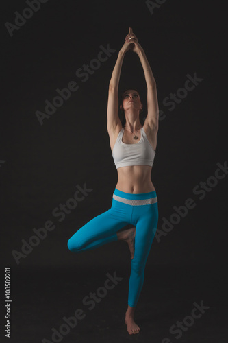 Beautiful sporty yogi girl practices yoga asana