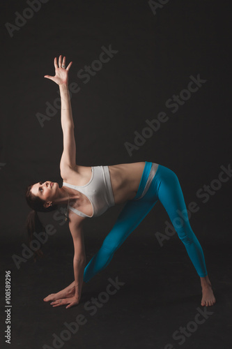 Beautiful sporty yogi girl practices yoga asana