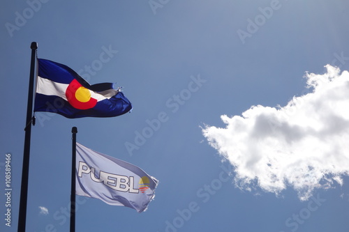 Pueblo, Colorado Flags - Backlit with Cloud