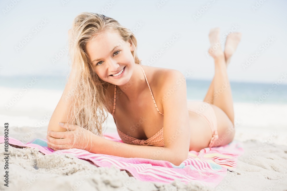 Happy woman in bikini lying on the beach Happy woman in bikini lying on the beach