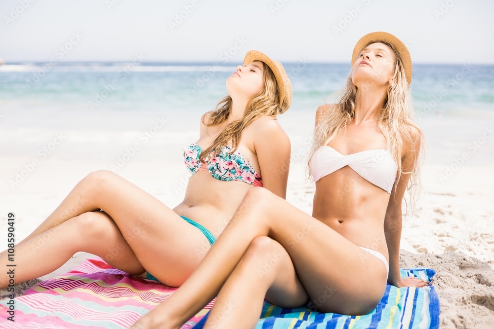 Two pretty women relaxing on the beach